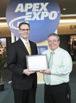 “David Raby, president and CEO of STI Electronics, Inc. receives QML award at IPC APEX EXPO 2015 from John Mitchell, president and CEO of IPC.”