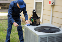 Figure 1: Maintenance staff works on an exterior unit of a central air conditioner.