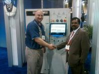 Accurex's Ram Mohann (right) purchases Aqueous Technologies’ Trident III from Kevin Buckner (left) during the recently held IPC/APEX Expo in Las Vegas.