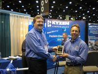 Eric Bromley (left), Kyzen Regional Manager, congratulates Terry O’Neal (right) on winning the award.